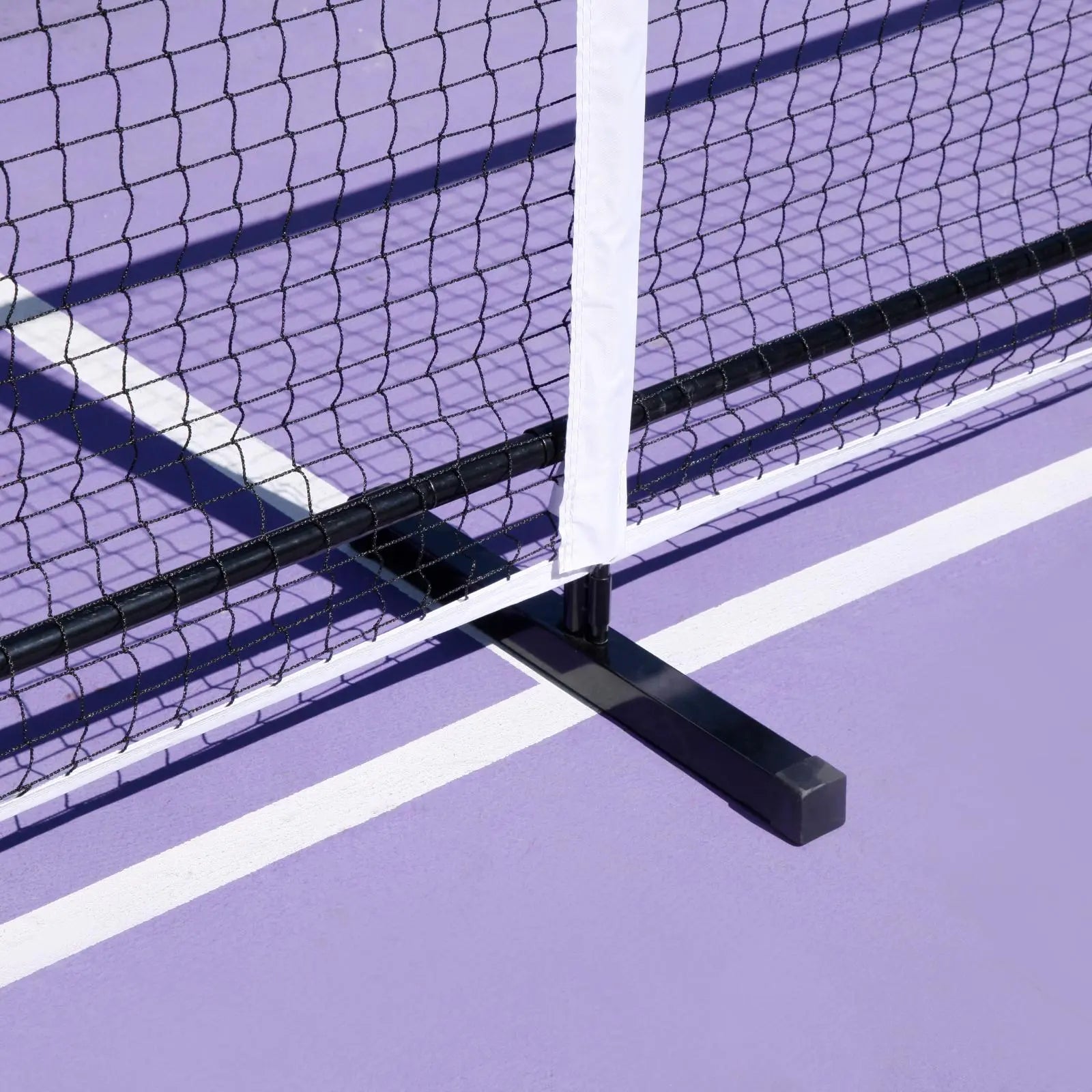 Black Luft 6.8M pickleball net with white PVC oxford cloth band on a purple court.