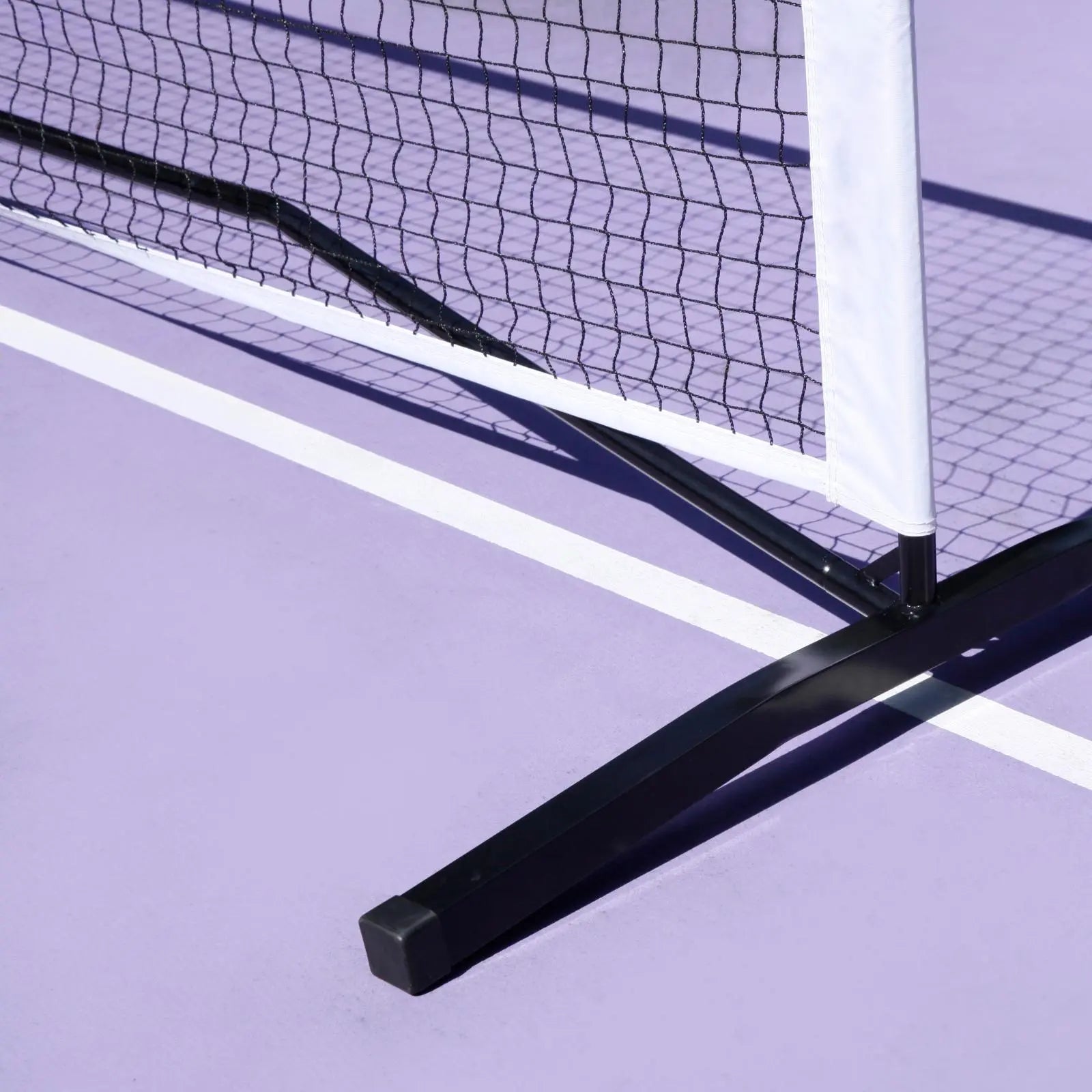 Luft 6.8M black pickleball net with white PVC oxford cloth band on a lavender court.