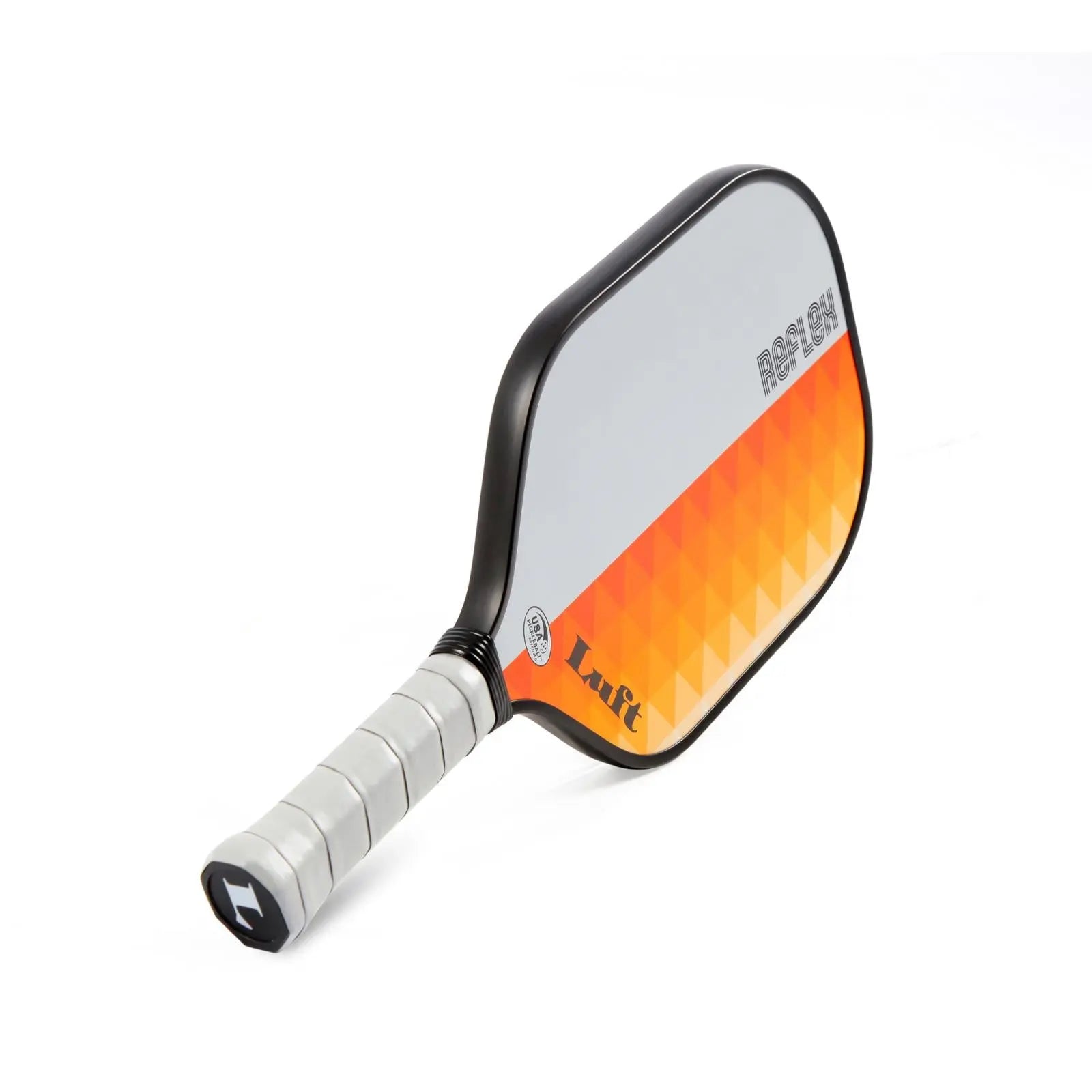 Luft Reflex pickleball paddle with a grey and orange geometric face, black frame, and grey grip.