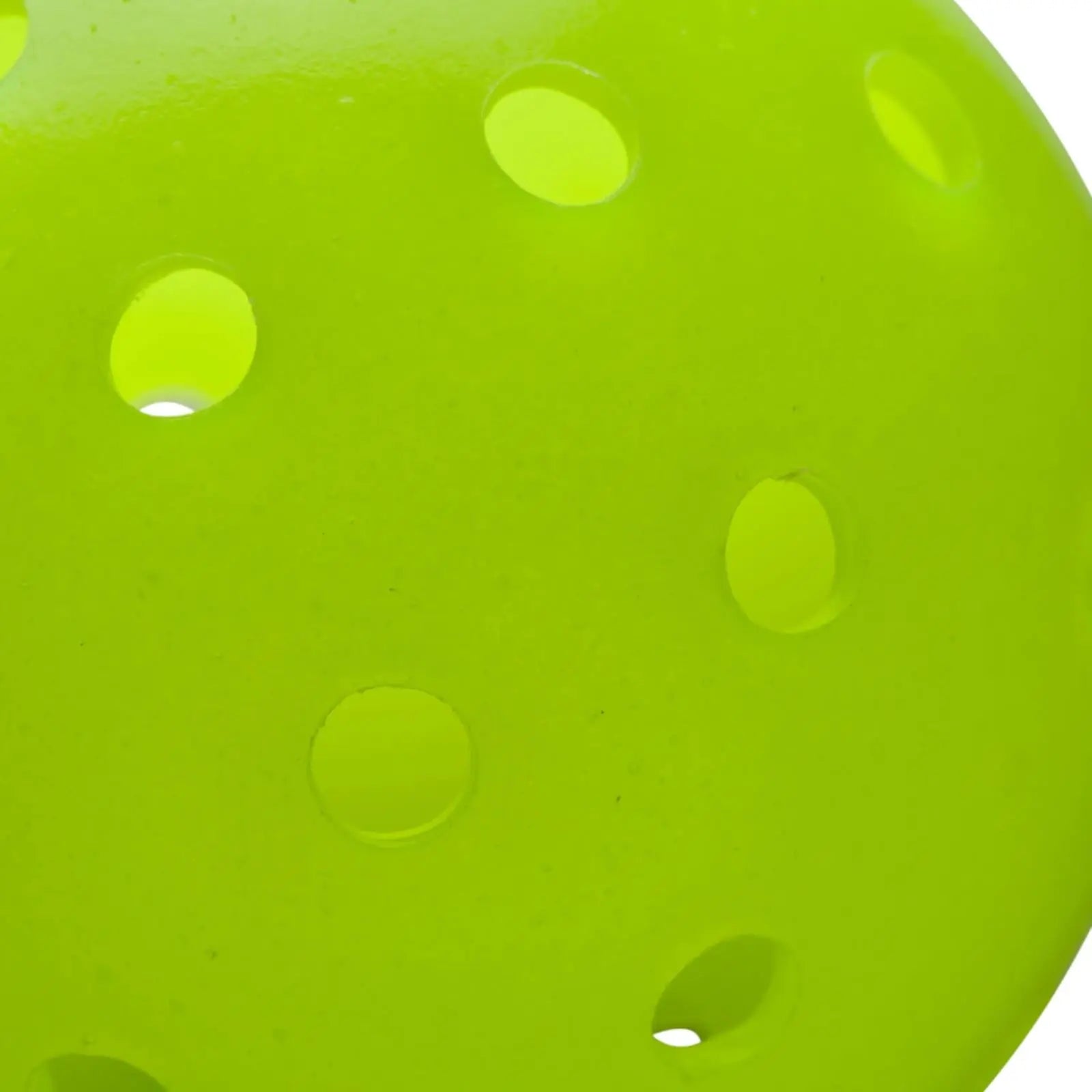 Close-up of a single bright neon green Wilson outdoor pickleball with visible 40-hole design.