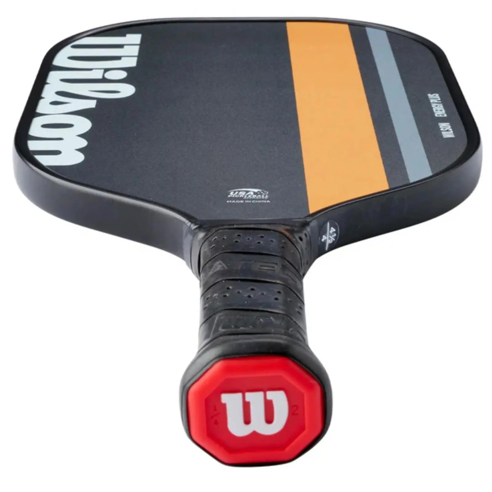 Black Wilson pickleball paddle with orange and gray stripes, a textured grip, and red butt cap.