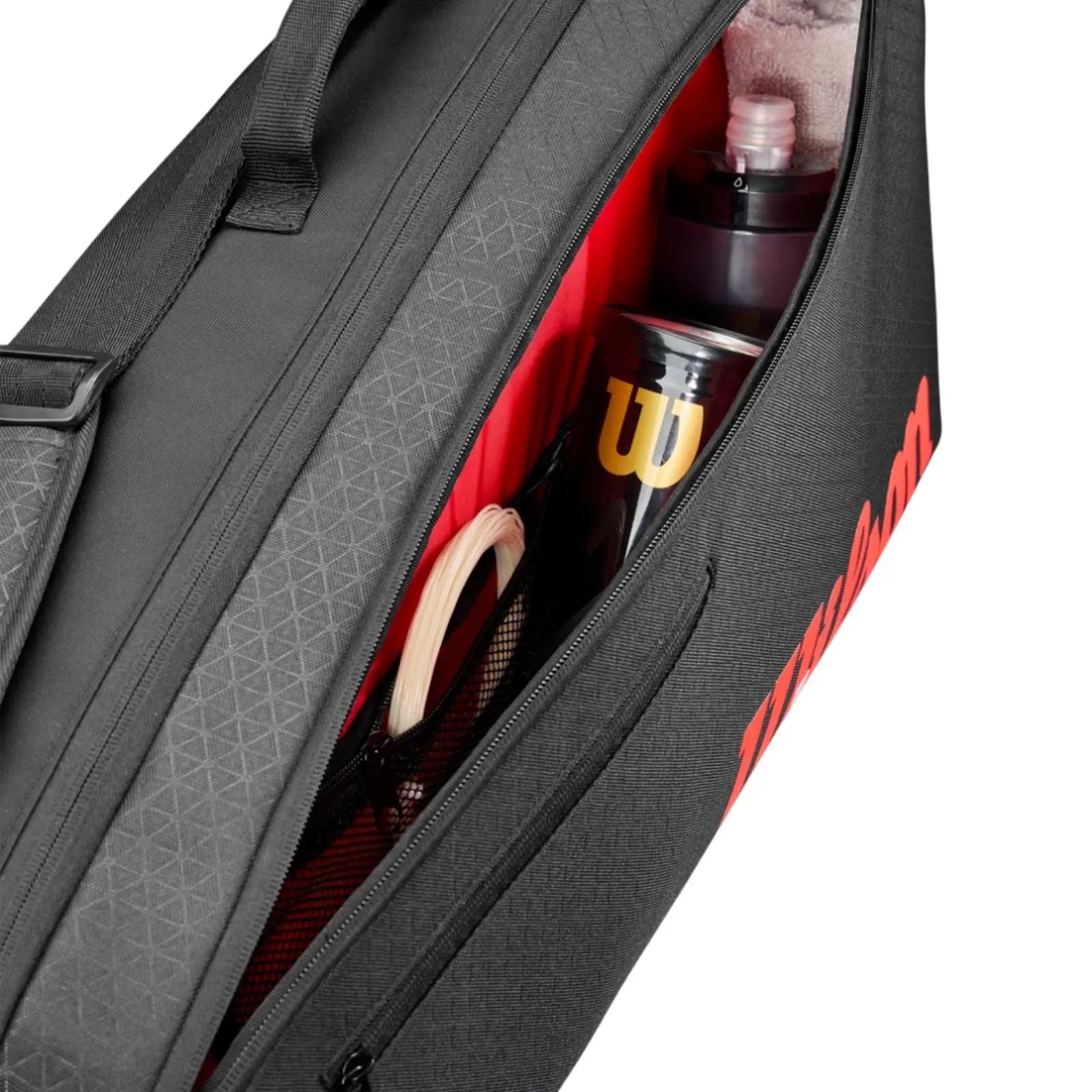 Black Wilson Super Tour Clash v3 tennis bag with red interior, holding a water bottle, tennis balls, and string.