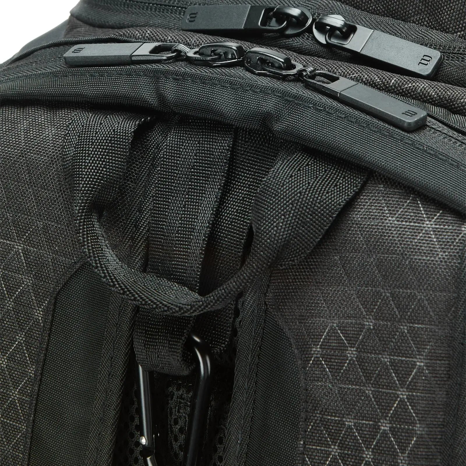 Close-up of a black Wilson Super Tour Clash v3 tennis backpack with textured fabric and zipper pulls.