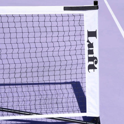 Luft 6.8M pickleball net, black mesh with white PVC oxford cloth border, on a purple court.