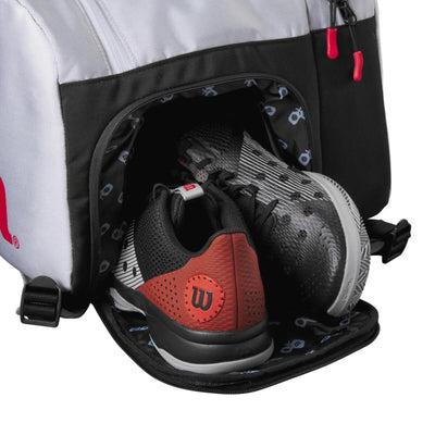 Wilson Super Tour Pickleball Bag in gray, black, and red, showing a ventilated shoe compartment with two shoes.