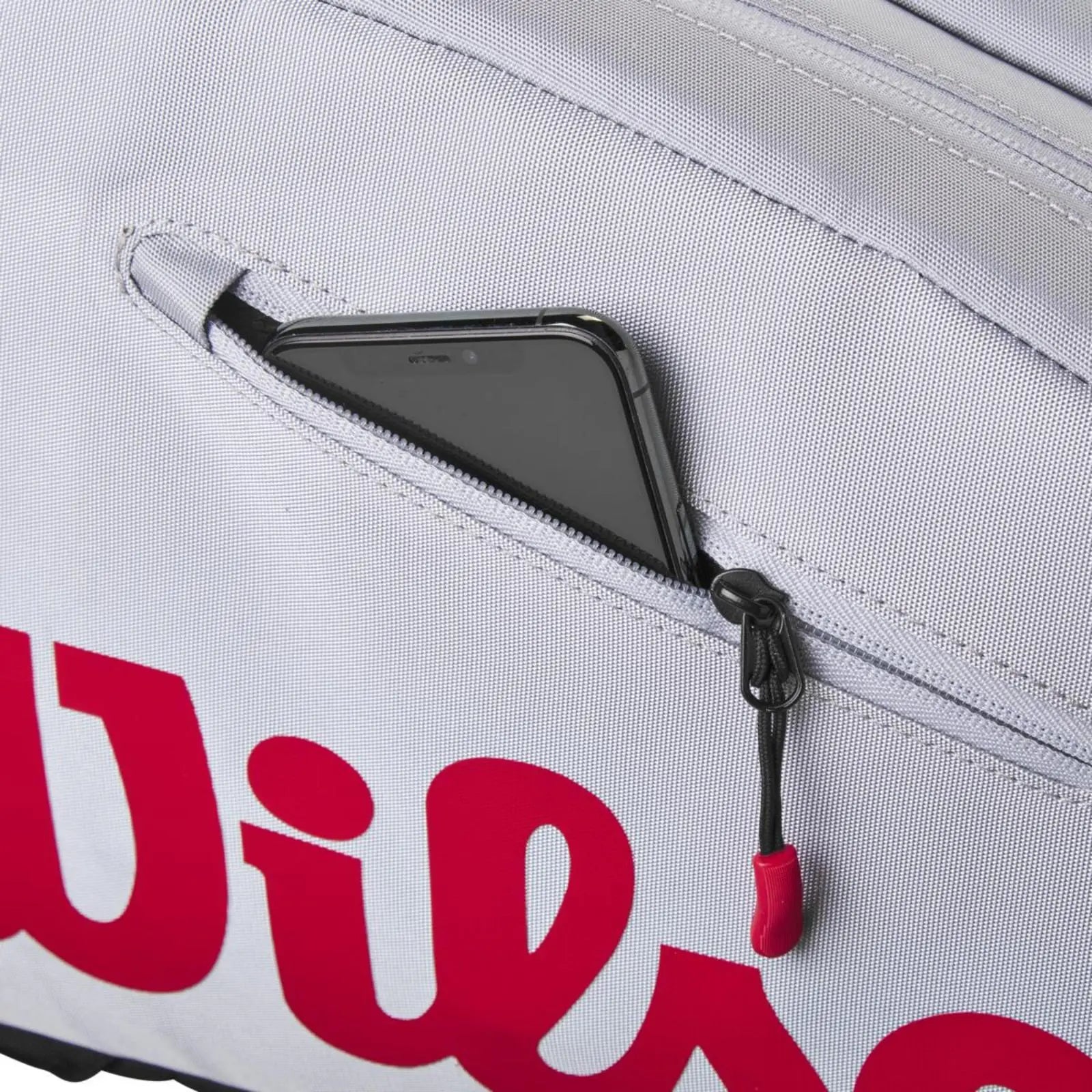Wilson Super Tour Pickleball Bag in gray with red logo, showing a phone in a zippered pocket.