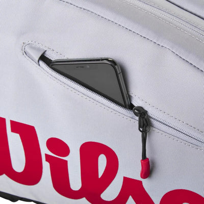 Wilson Super Tour Pickleball Bag in gray with red logo, showing a phone in a zippered pocket.