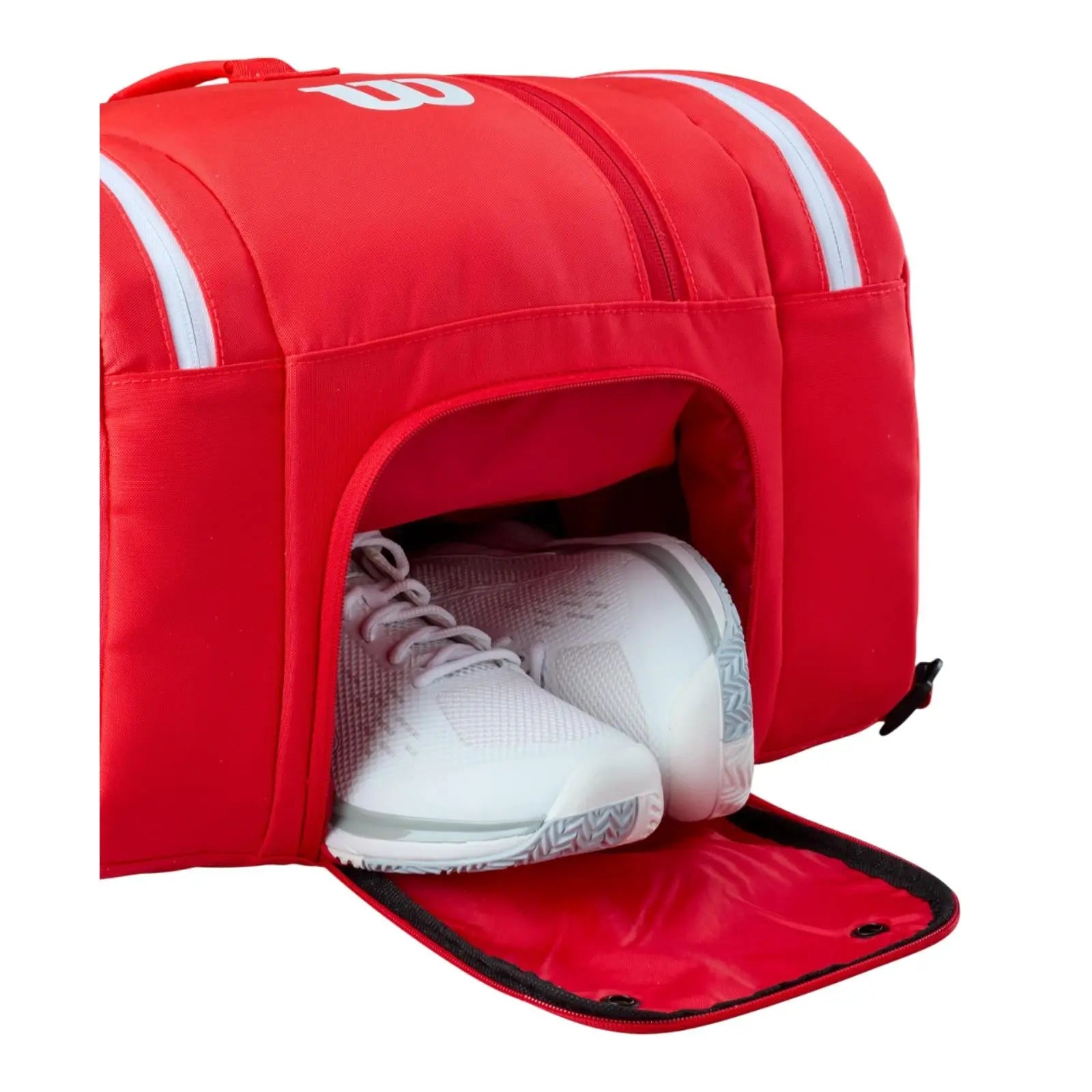 Red Wilson Super Tour pickleball bag with a dedicated shoe compartment holding white athletic shoes.