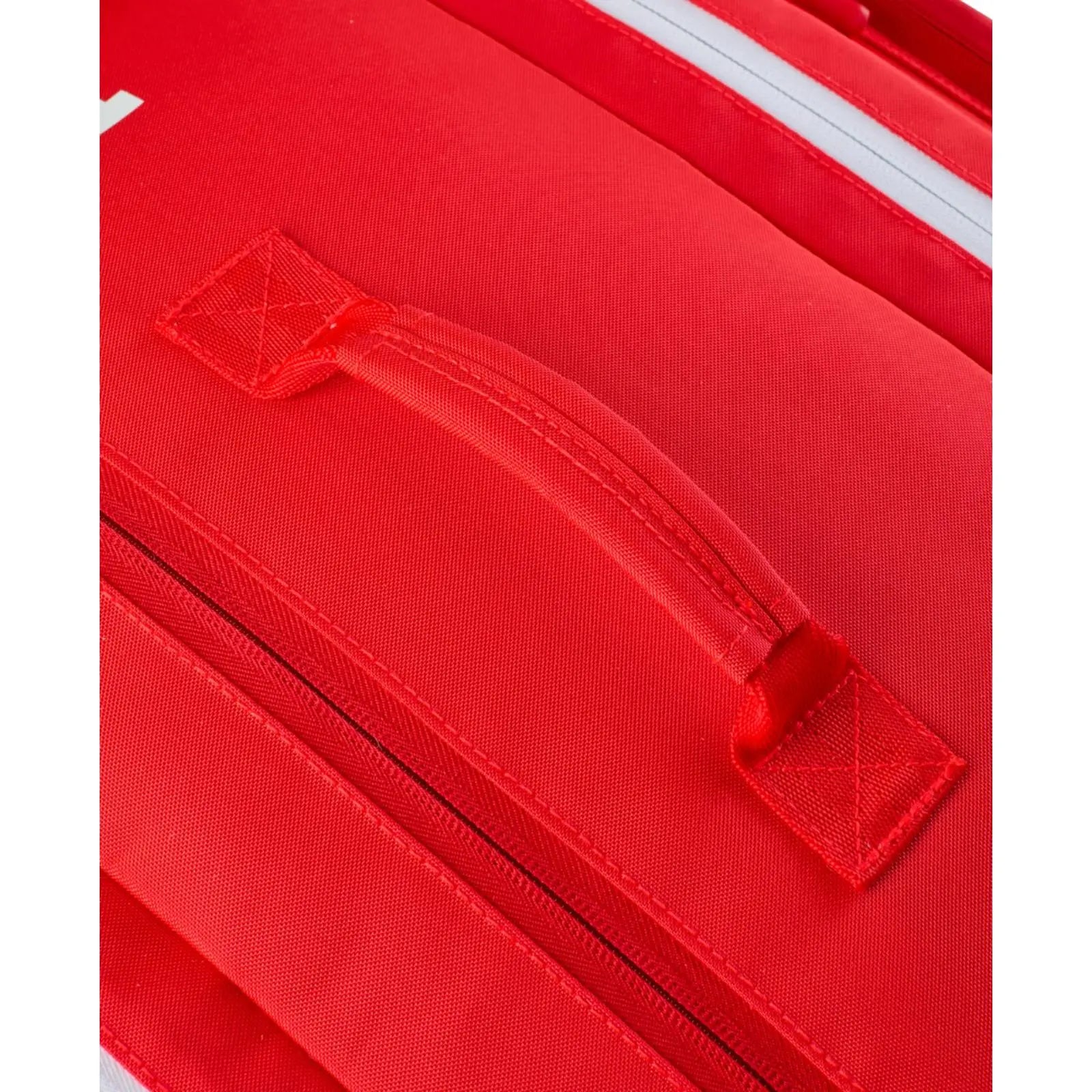 Close-up of the red Wilson Super Tour pickleball bag, showing its top handle and zippered compartments.