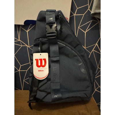 Dark blue Wilson Triangle Pickleball Sling Bag with a top hanging hook and exterior accessory compartment.
