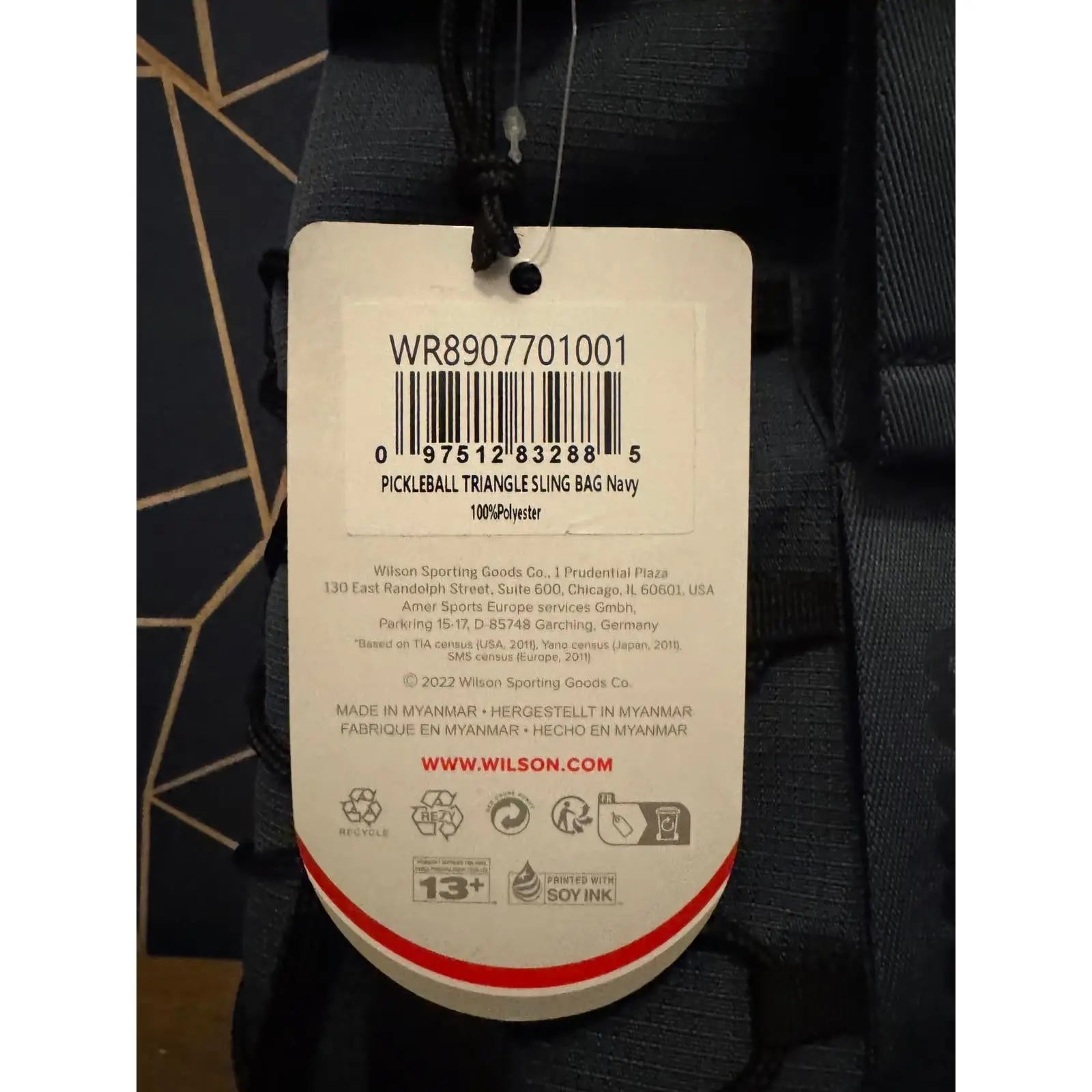 Navy blue Wilson Pickleball Triangle Sling Bag with product tag, 100% polyester.