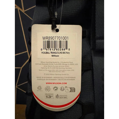 Navy blue Wilson Pickleball Triangle Sling Bag with product tag, 100% polyester.