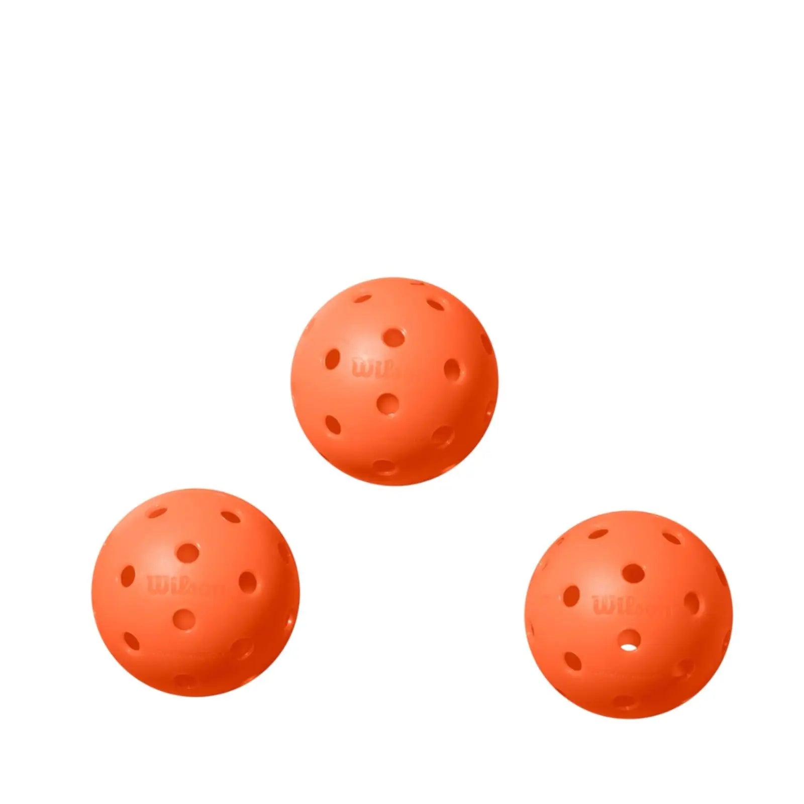 Three bright orange Wilson Tru 32 indoor pickleballs with 32 holes and a rough finish.