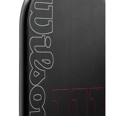 Close-up of the black Wilson Blaze Edgeless 13 pickleball paddle with white "Wilson" and red "13" logos.