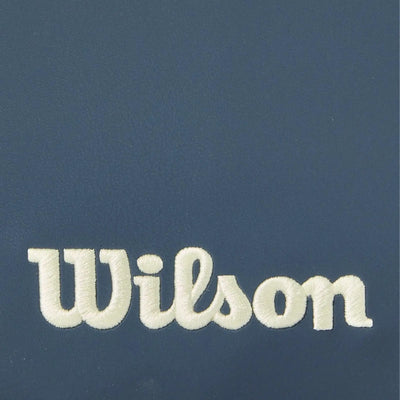 Close-up of a navy blue Wilson pickleball paddle cover with the brand name embroidered in cream.