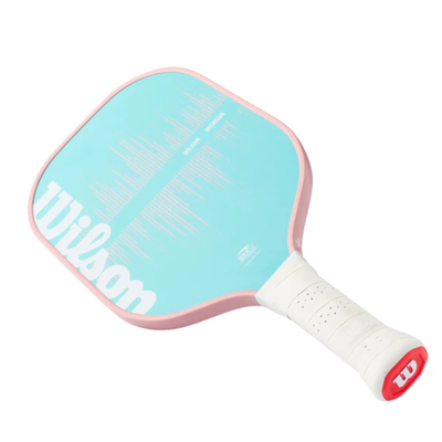 Wilson Intrigue pickleball paddle with a light blue face, pink edgeguard, and white grip.