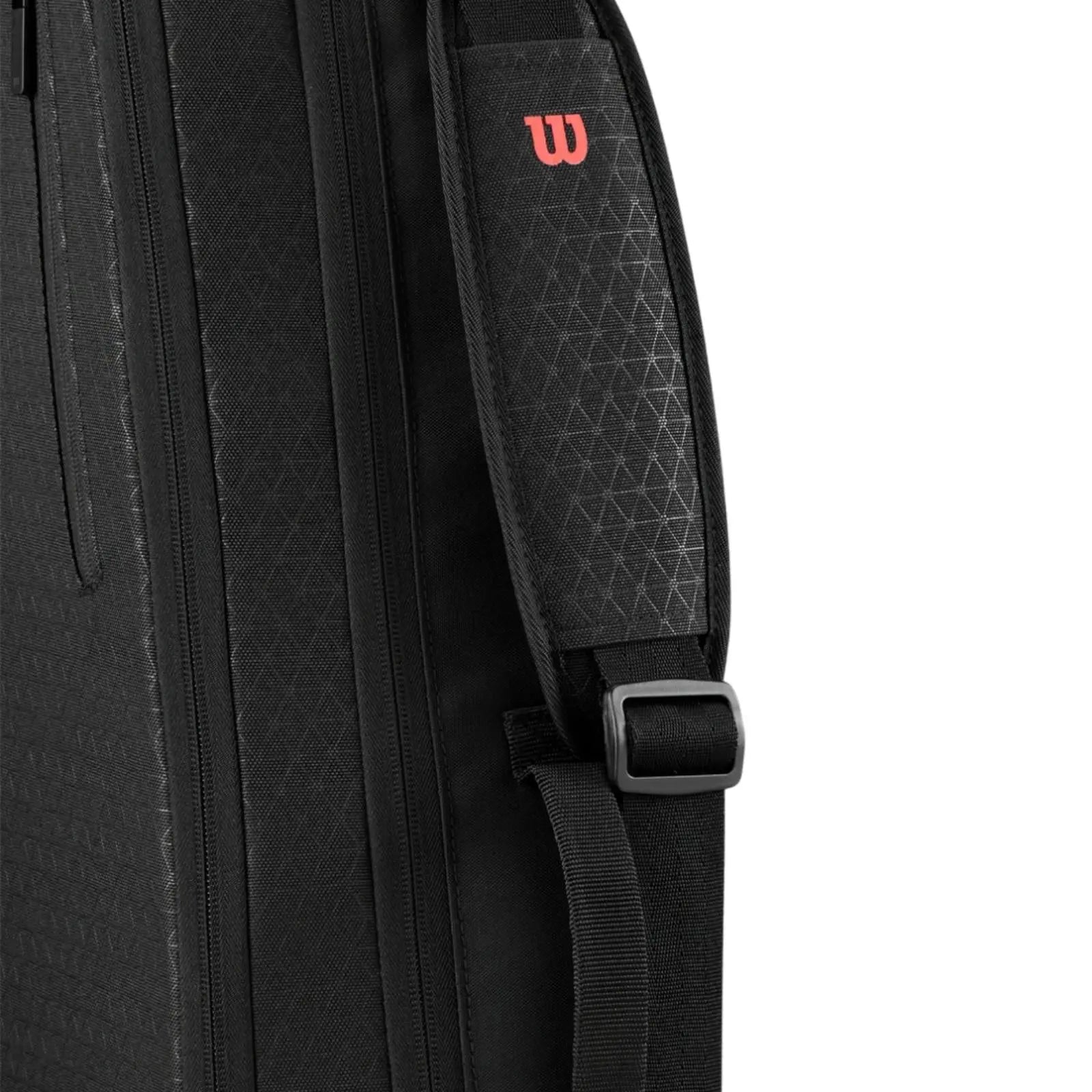 Black Wilson Super Tour Clash v3 tennis bag with subtle triangle pattern and red "W" logo on shoulder strap.