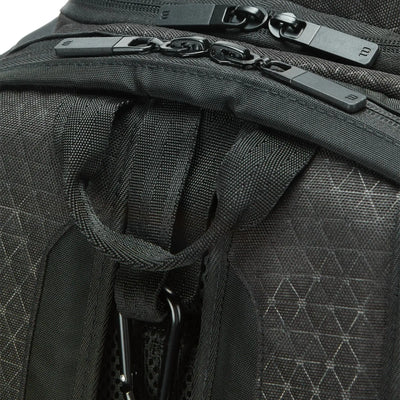 Close-up of a black Wilson Super Tour Clash v3 tennis backpack with textured fabric and zipper pulls.