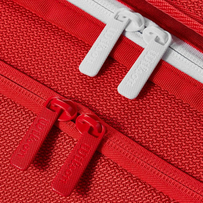 Close-up of a red Wilson Super Tour tennis bag with red and white zipper pulls.