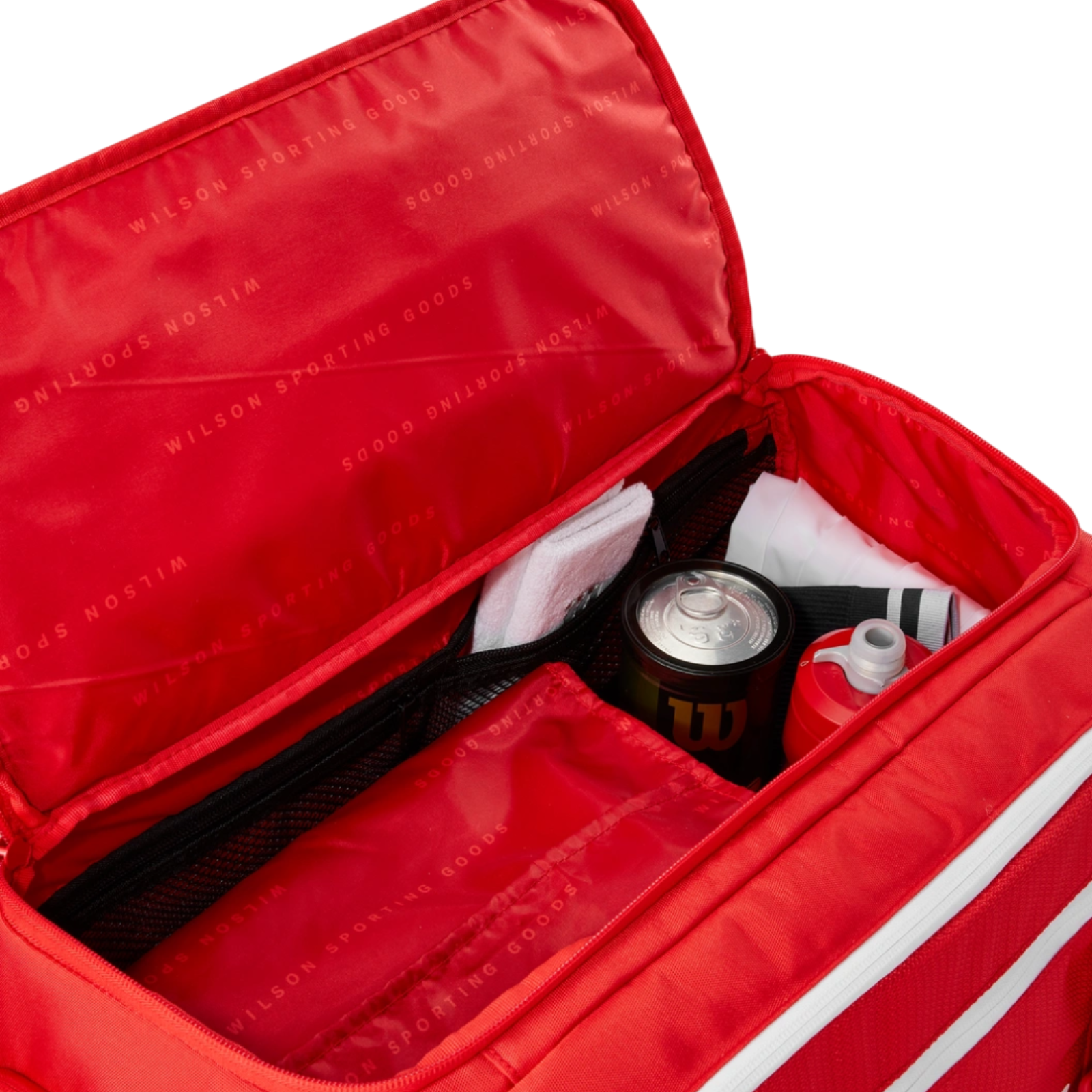Red Wilson Super Tour Small Duffel tennis bag, open, showing interior compartments with a drink, shirt, and towel.