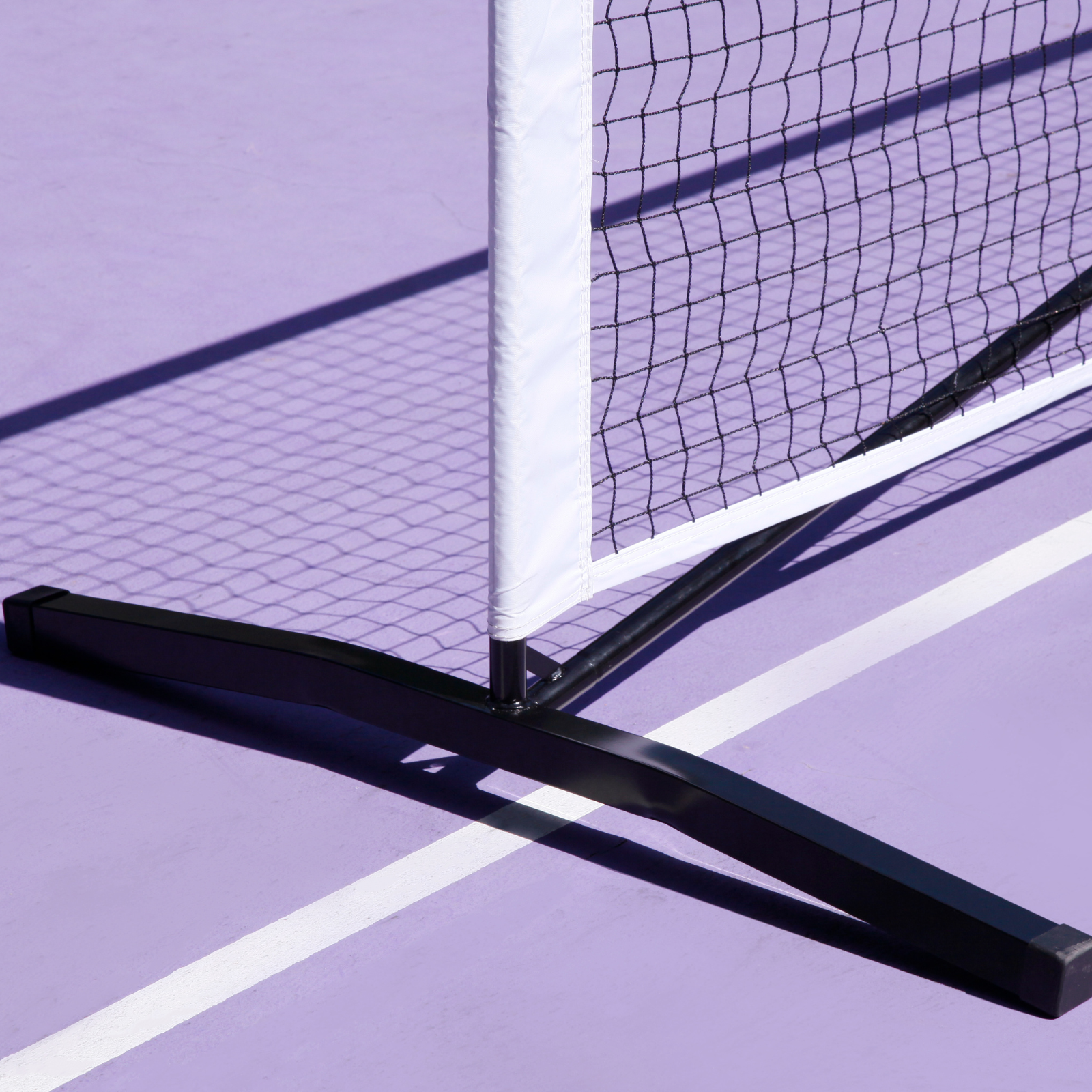 Luft heavy-duty 6.8M pickleball net with black steel base and white PVC oxford cloth sleeve on a purple court.