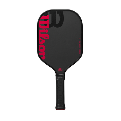 Black Wilson Blaze Pro 13mm pickleball paddle with red Wilson logo and text, featuring a raw hybrid surface.